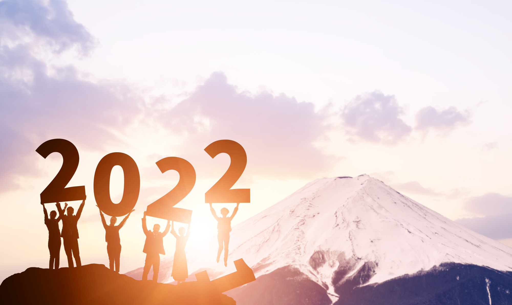 Mountain with people holding up numbers 2022